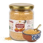 Moumachi Date Palm Jaggery Nolen Dust jar with a small decorative bowl and brass scoop