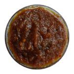 Top down view of Moumachi Chalta Tok Jhal Mishti sauce in a bowl showing thick texture
