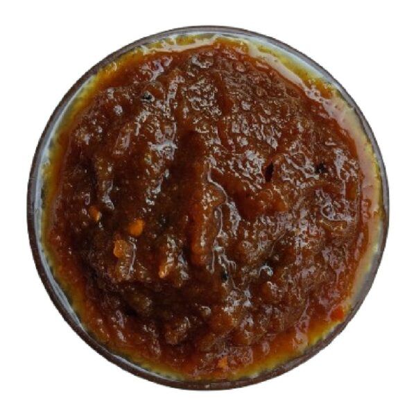 Top down view of Moumachi Chalta Tok Jhal Mishti sauce in a bowl showing thick texture