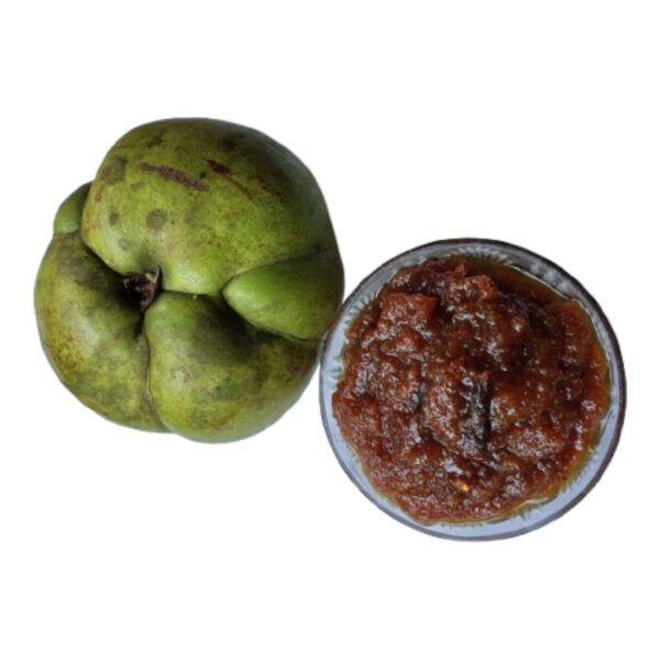 Whole fresh green Elephant Apple alongside a bowl of Moumachi Chalta Tok Jhal Mishti sauce
